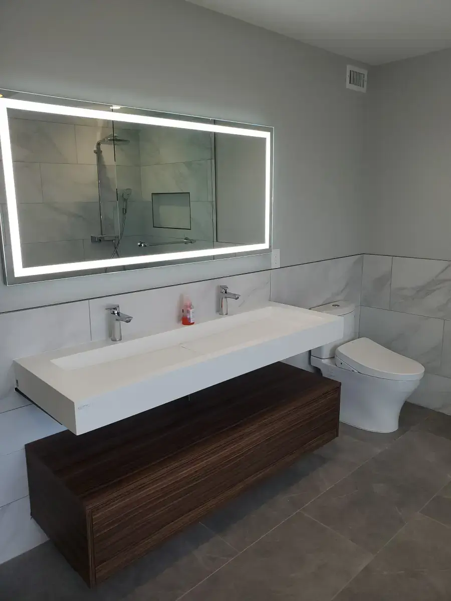 Modern bathroom with illuminated mirror and sink